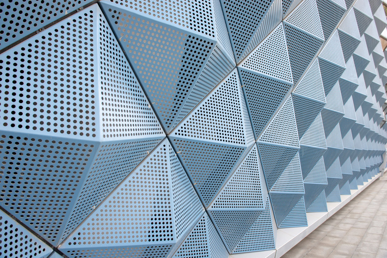 Folded perforated metal panels on a building facade