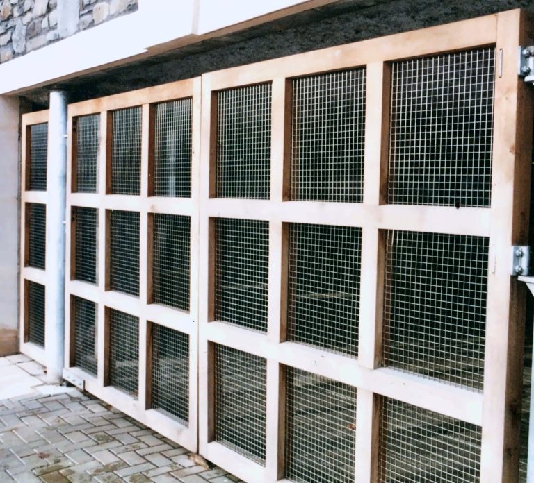 Timber-framed screen with woven wire mesh infill