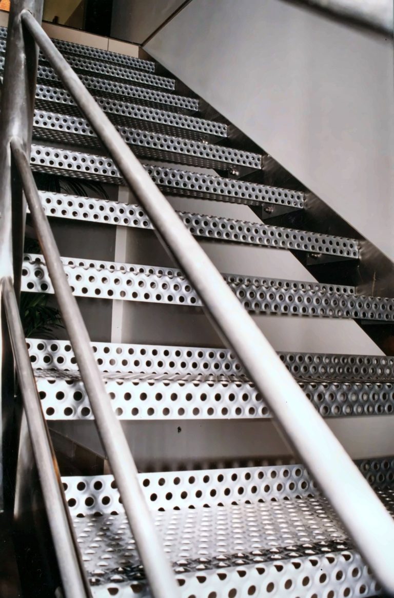 Perforated metal staircase seen from below