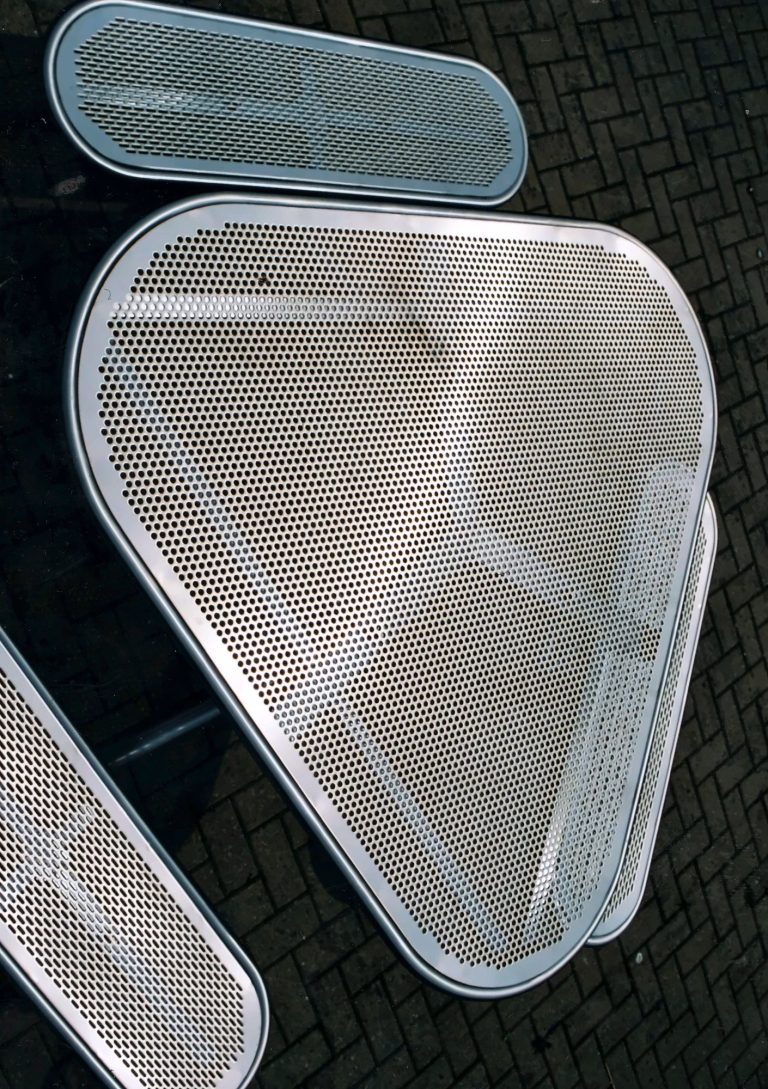 Picnic table with a perforated metal top