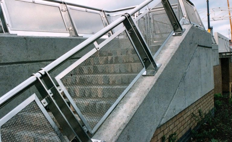 Staircase with mesh balustrade panels, seen from below