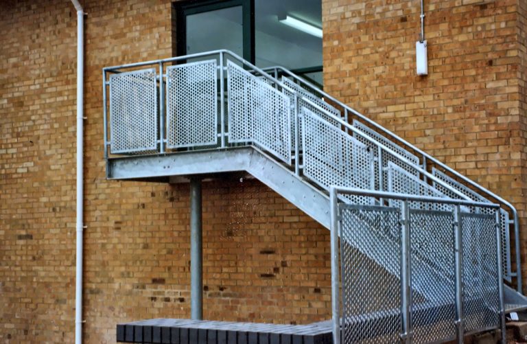 External staircase with mesh balustrade panels
