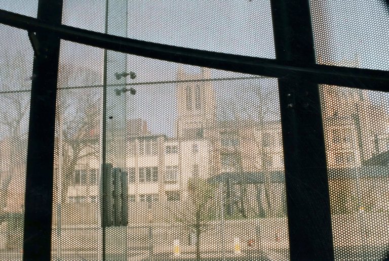 Perforated metal screen in front of a window