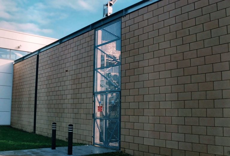 Building facade clad in perforated metal panels