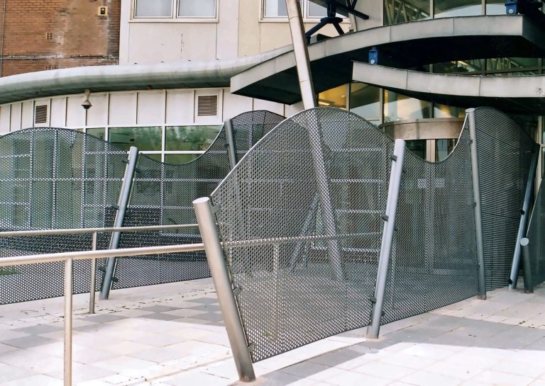 Curved perforated metal fence