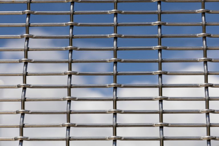 Heavy crimped stainless steel architectural mesh against the sky